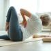 person applying ice pack to lower back while lying on comfortable surface