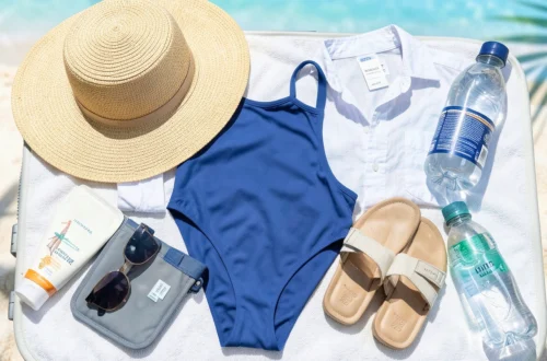 Organized beach vacation packing essentials laid out on bed