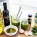 Fresh homemade salad dressing in glass jar with olive oil and herbs